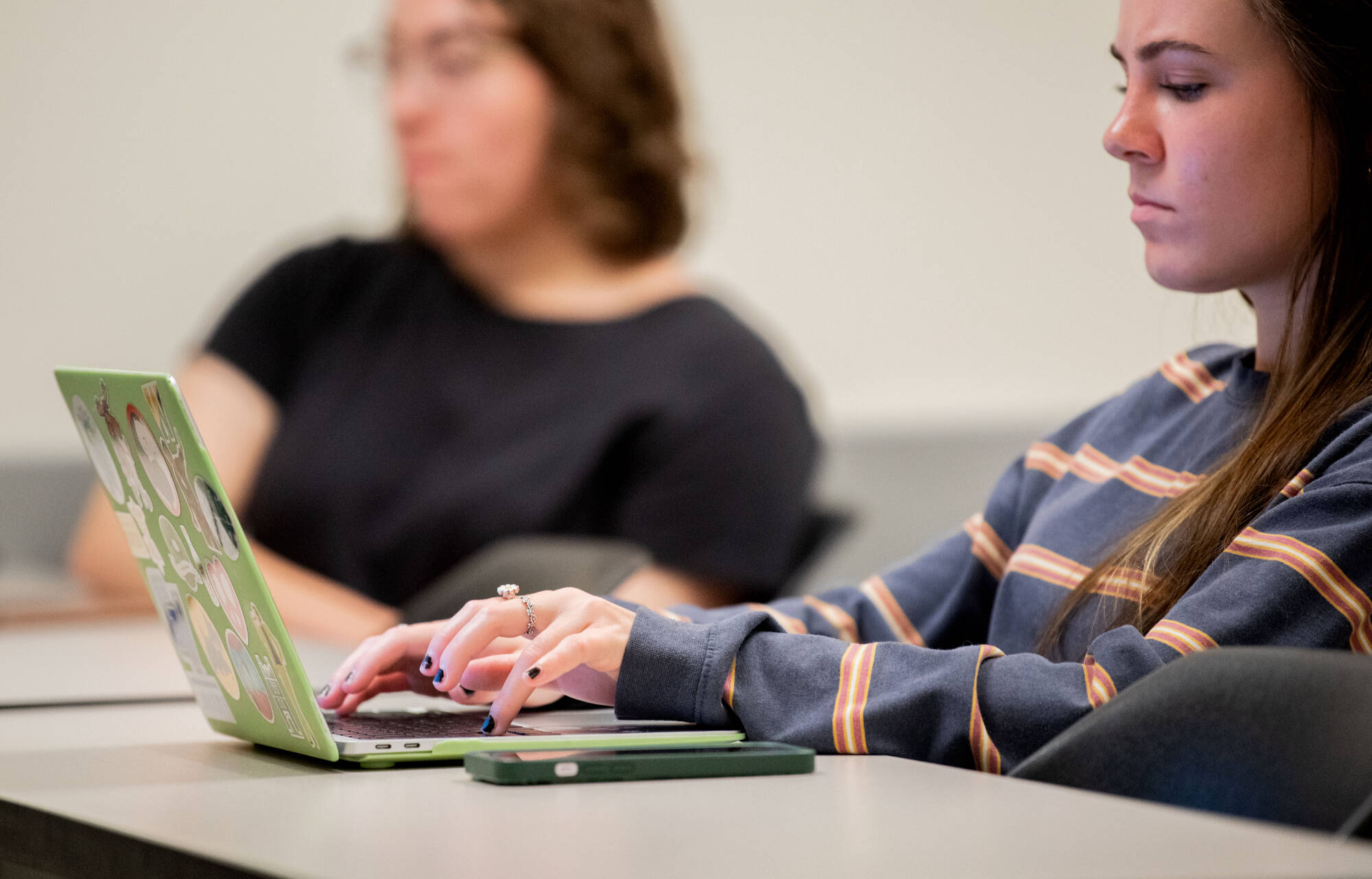Brianna Bumgardner listens to Alisha Karabinus, assistant professor of writing, during class on October 4 while working on her laptop. Karabinus uses AI tools in her writing and digital studies classes.